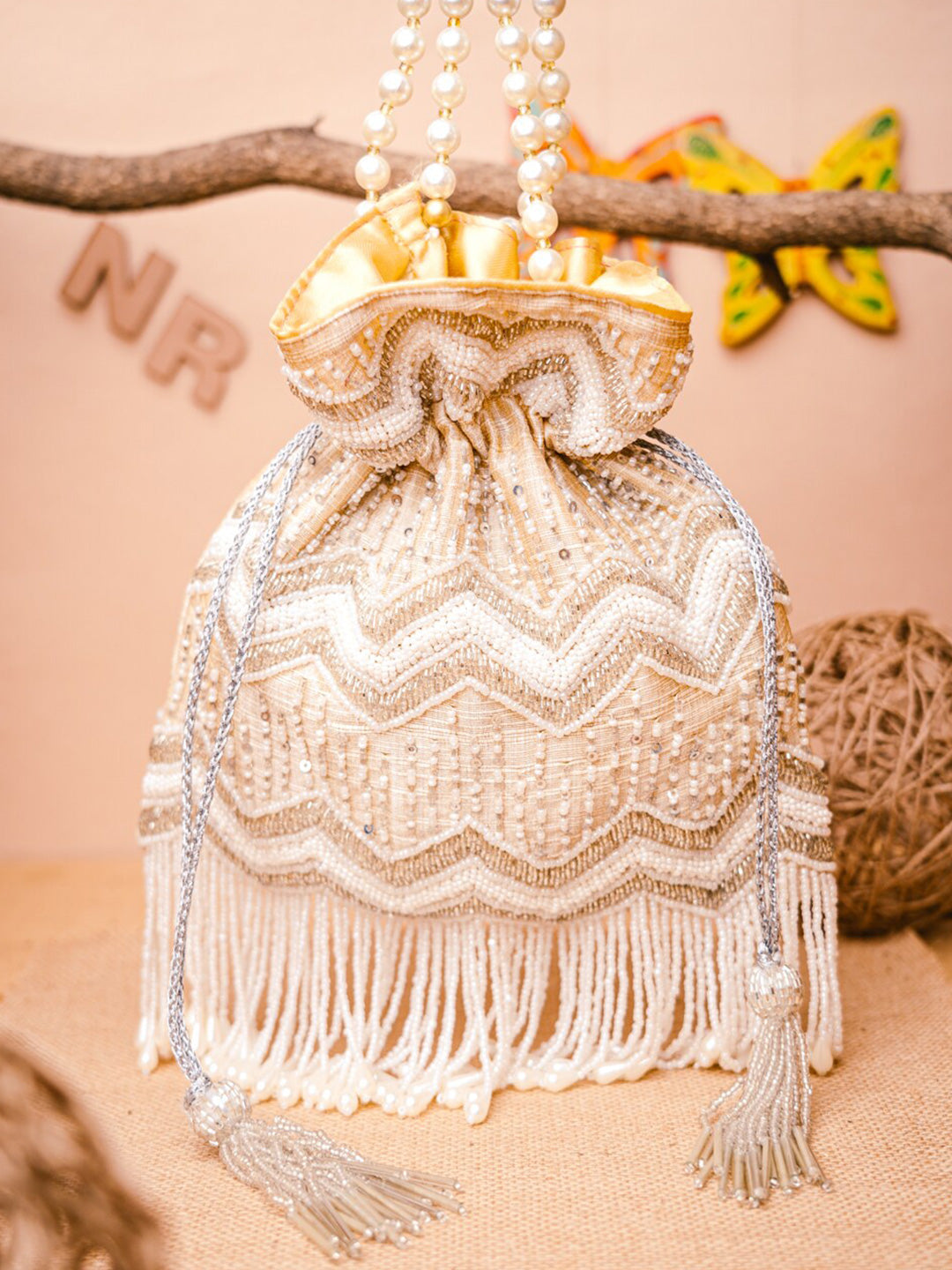 NR By Nidhi Rathi Cream-Coloured & Gold-Toned Embellished Potli Clutch - Grab2buy