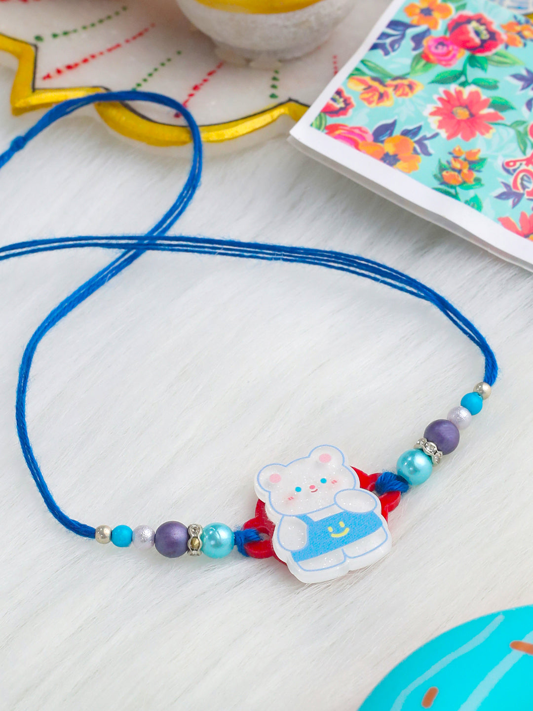 NVR Kids Teddy Blue Artificial Beads Thread Rakhi with Roli Chawal Chandan & Mishri | Grab2Buy