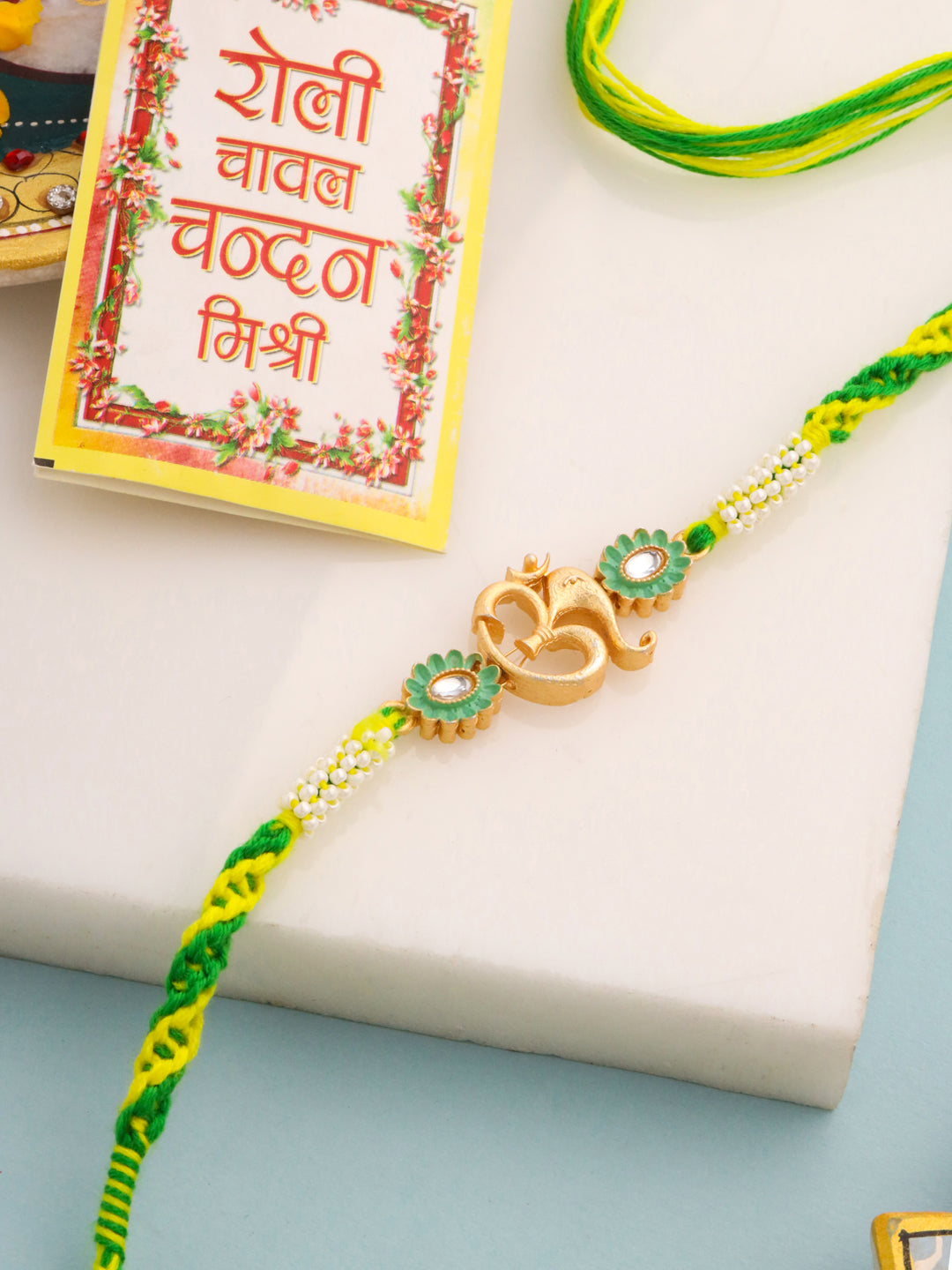 NVR Men Green Kundan Studded Om Design Thread Rakhi with Roli Chawal Chandan & Mishri | Grab2Buy