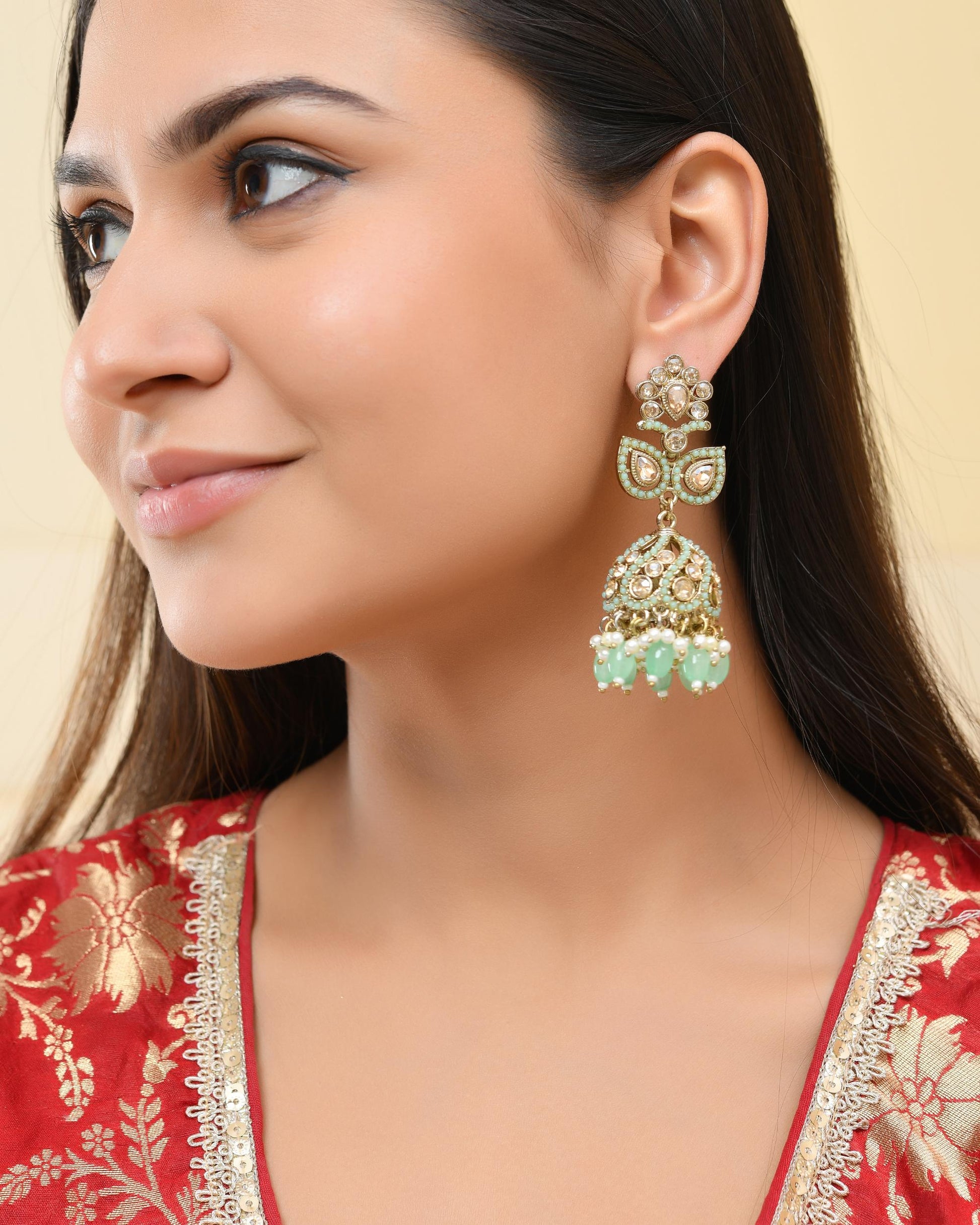 VOJ Mint Green Stone Studded Gold-Polished Jhumkas VOJ (Valley Of Jewellery)