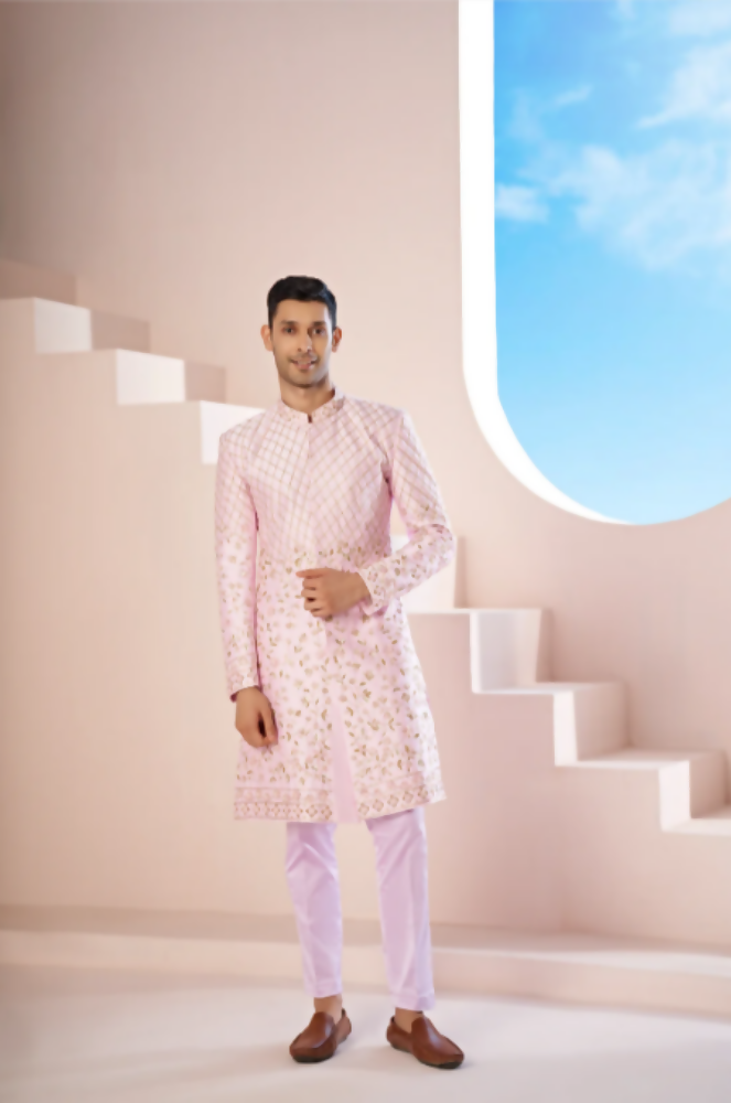 A Pink Sherwani Featuring Elegant Cross-Line Patterns Adorned With Intricate Floral Designs by Hilo Design 